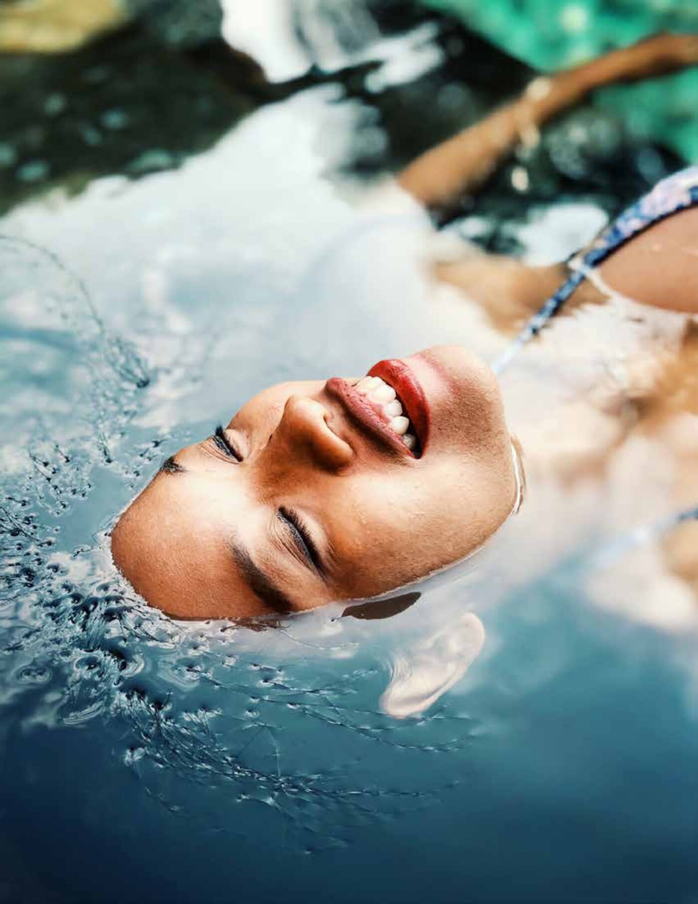 A face floating peacefully in a clear pool — Green Lab brand mood