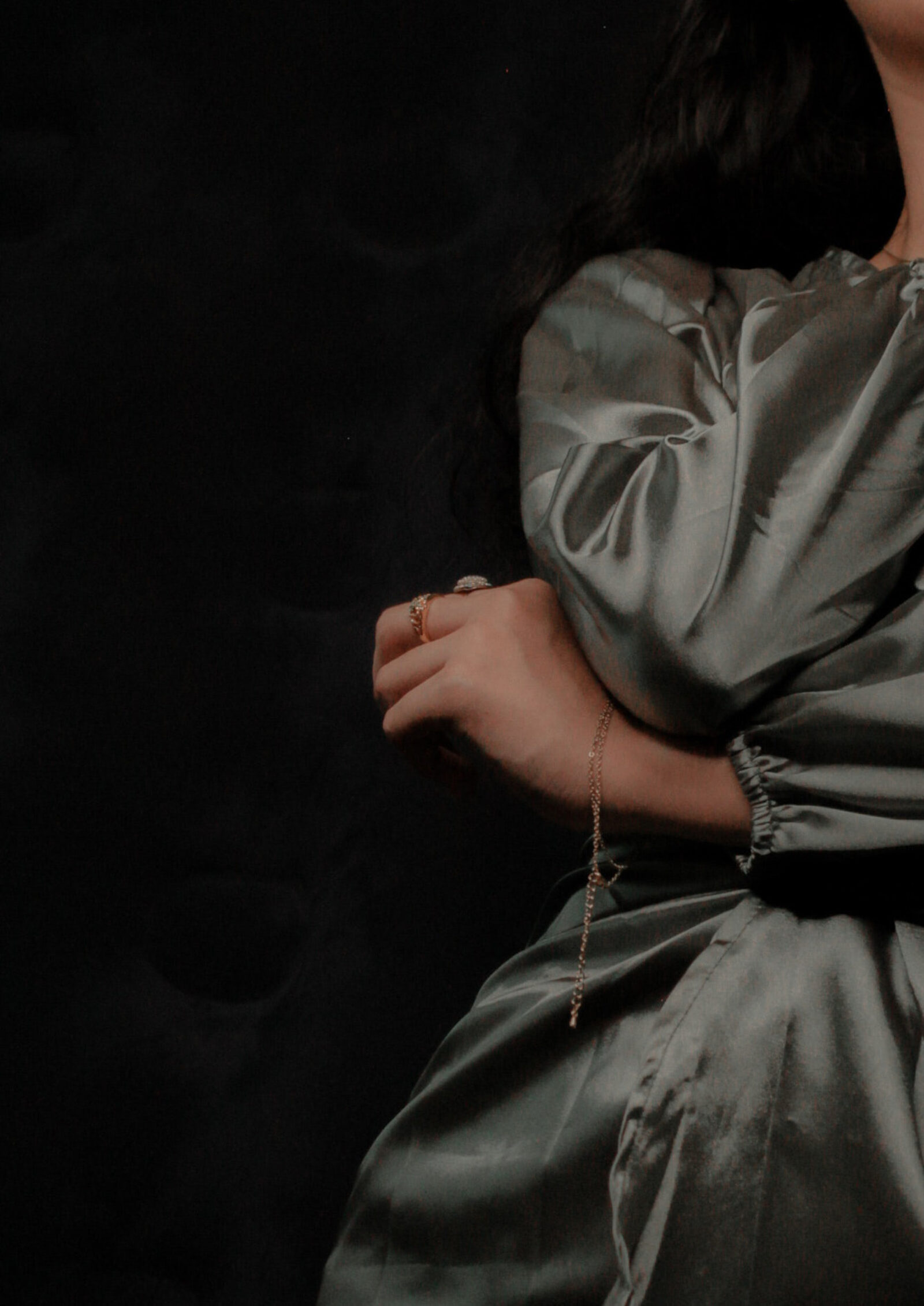 Sasstain — sage silk dress against deep shadow